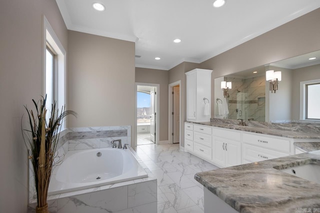 full bath with a bath, a shower stall, vanity, and ornamental molding