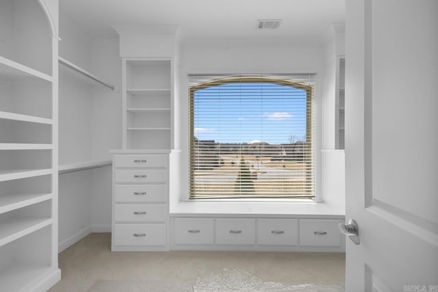 spacious closet featuring light colored carpet and visible vents