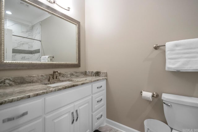 bathroom with visible vents, toilet, a marble finish shower, baseboards, and vanity