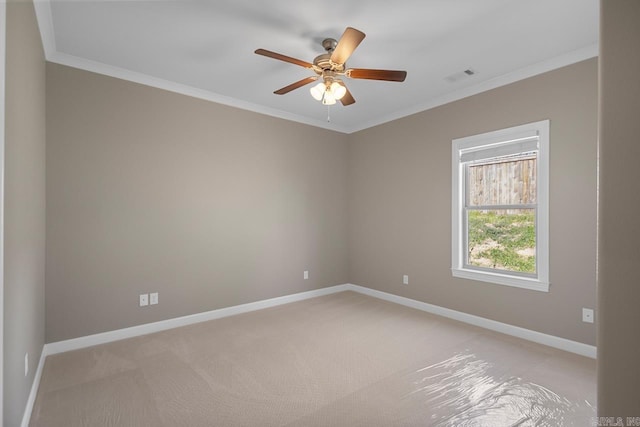 empty room with crown molding, baseboards, and visible vents