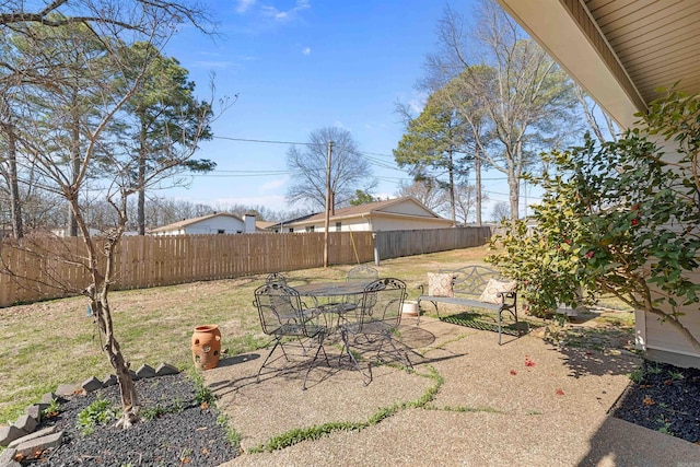 exterior space with outdoor dining space and a fenced backyard