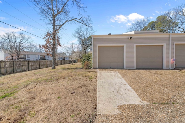 detached garage featuring fence