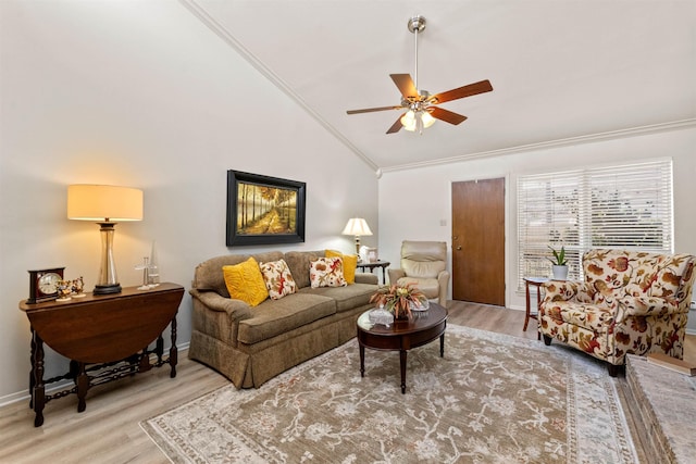 living area with wood finished floors, crown molding, ceiling fan, and vaulted ceiling