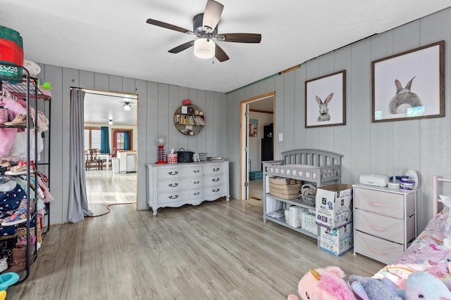 bedroom with light wood-type flooring and a ceiling fan