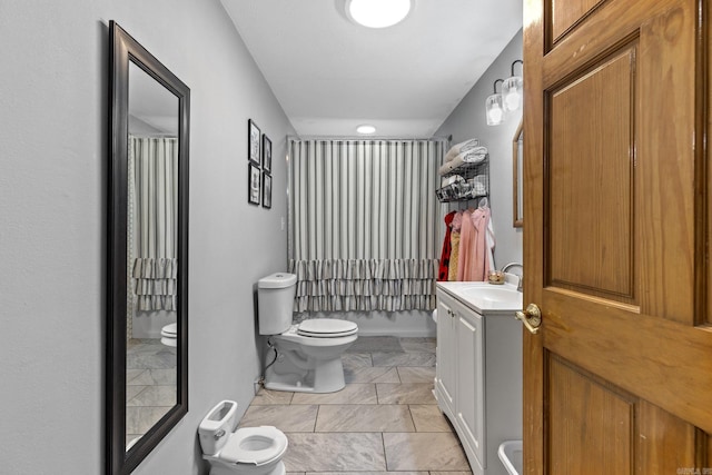 full bathroom with toilet and vanity