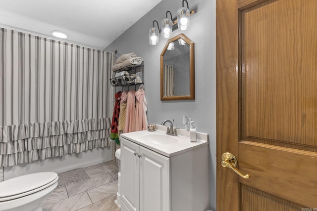 bathroom with vanity, toilet, shower / bath combo, and marble finish floor