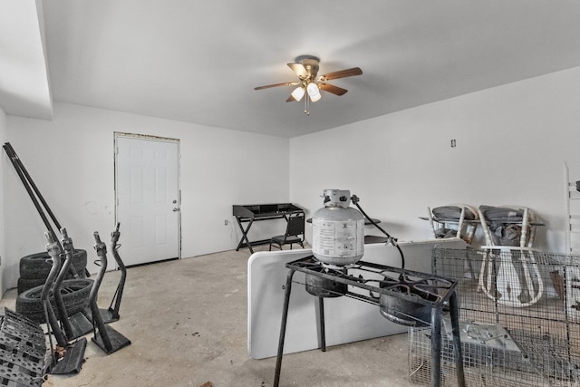 miscellaneous room with unfinished concrete floors and a ceiling fan