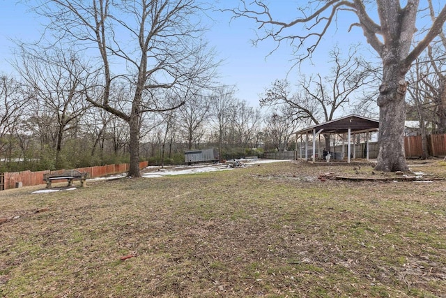 view of yard featuring a gazebo, an outbuilding, and fence