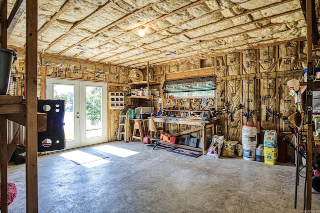 miscellaneous room featuring a workshop area and french doors