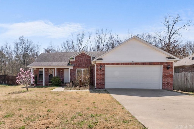 ranch-style home featuring brick siding, a front lawn, fence, concrete driveway, and a garage