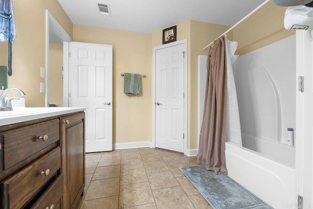 full bathroom with vanity, shower / bathtub combination with curtain, baseboards, visible vents, and tile patterned flooring