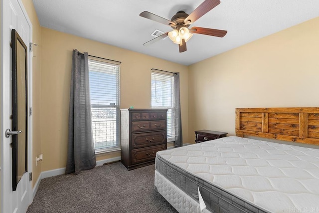 bedroom featuring carpet flooring, multiple windows, visible vents, and baseboards