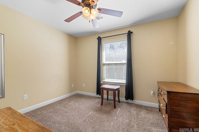 interior space with baseboards and a ceiling fan