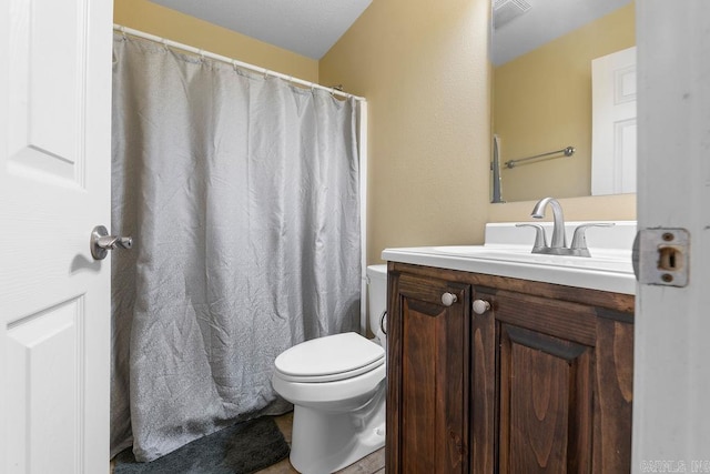 bathroom with visible vents, toilet, and vanity