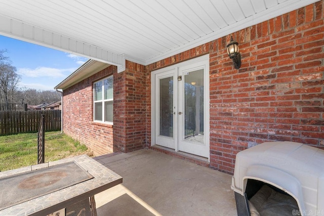 view of patio featuring french doors and fence