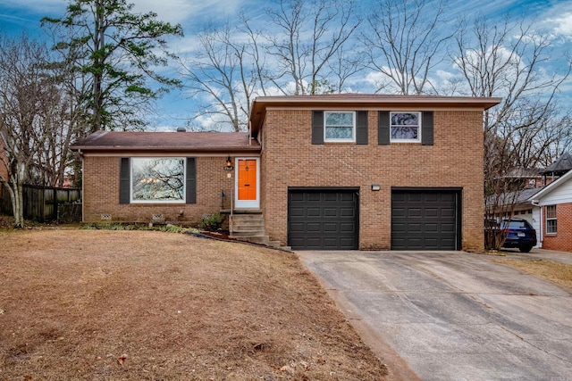 split level home featuring concrete driveway, an attached garage, and brick siding