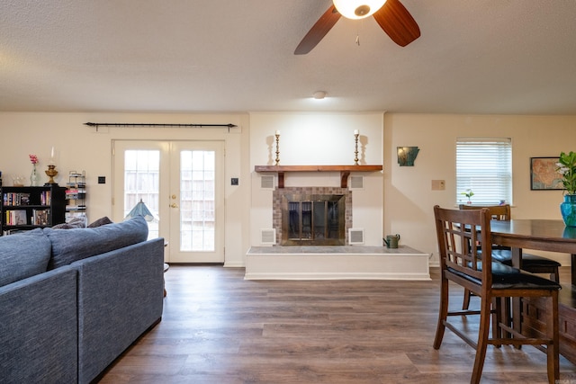 living area featuring dark wood finished floors, french doors, and a wealth of natural light