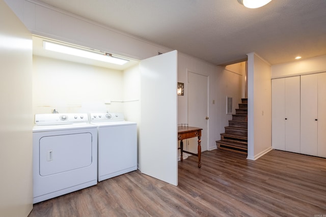 laundry area featuring laundry area, wood finished floors, independent washer and dryer, and visible vents