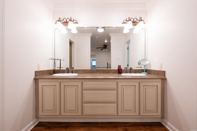 full bathroom with a sink, baseboards, ceiling fan, and double vanity