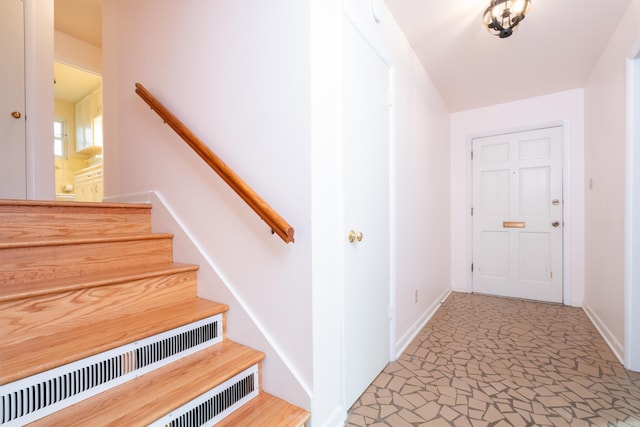 staircase featuring baseboards