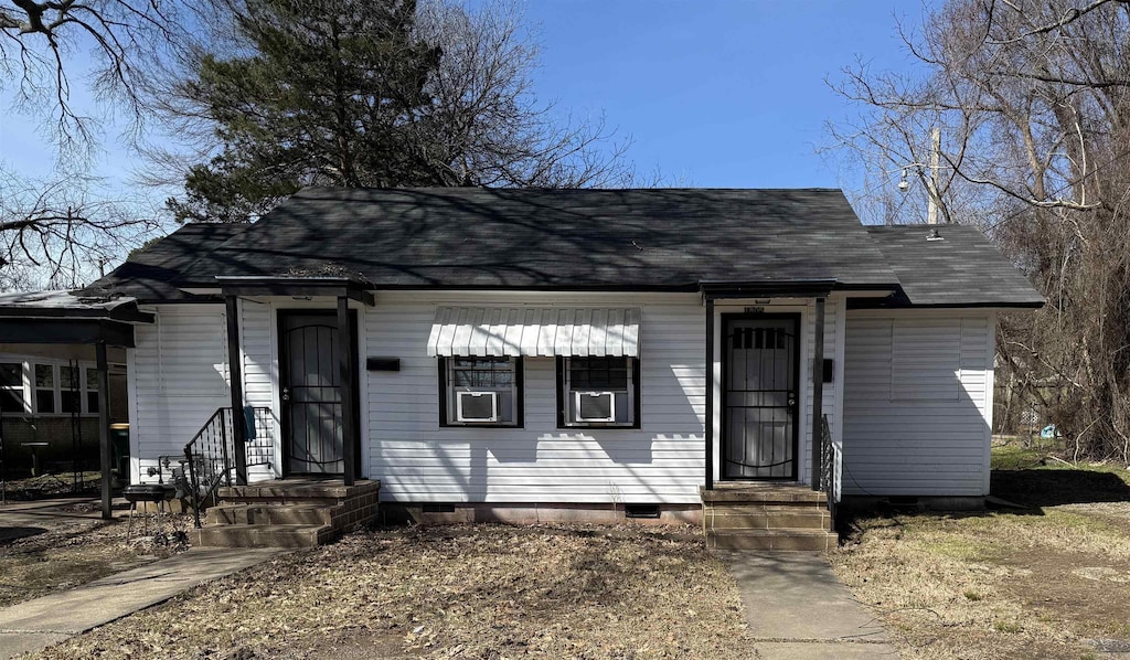 view of front of house with a shingled roof and crawl space