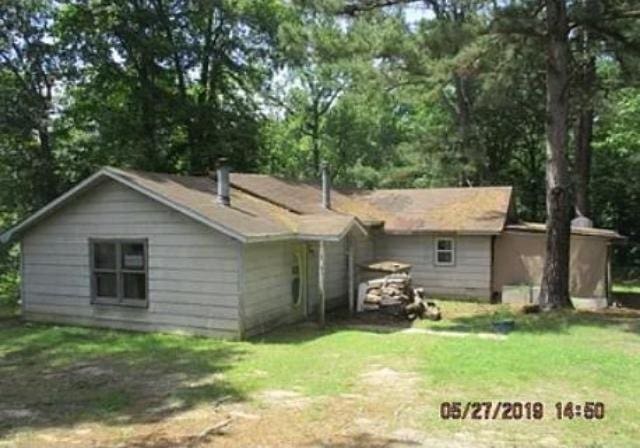 rear view of house with a lawn