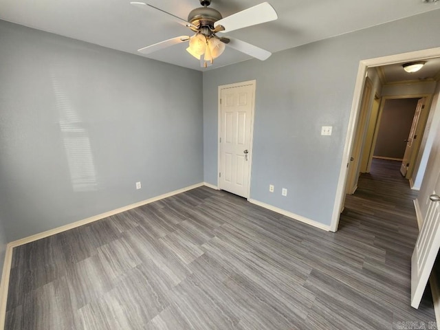 unfurnished bedroom featuring wood finished floors, a ceiling fan, and baseboards