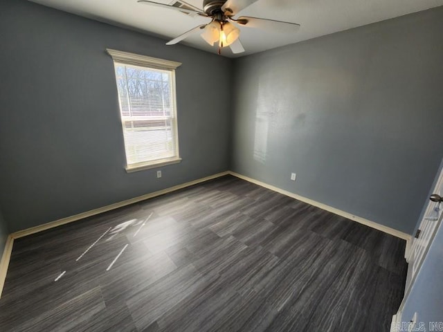 spare room featuring baseboards and ceiling fan