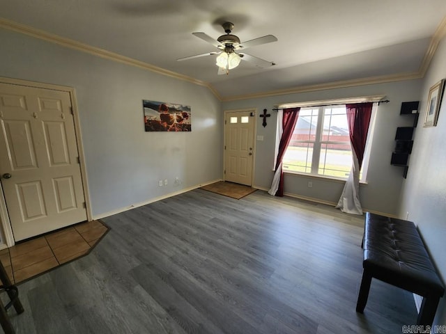 entryway with baseboards, crown molding, a ceiling fan, and wood finished floors