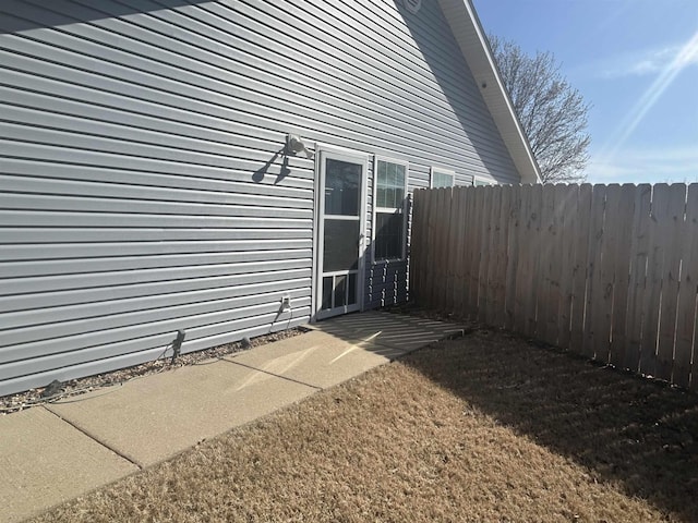 view of home's exterior with fence