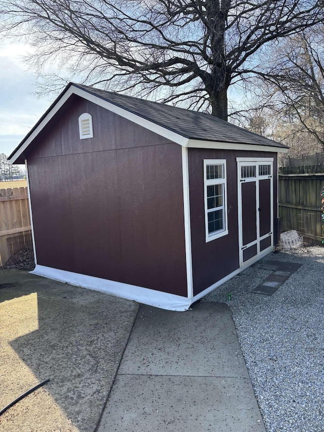 view of outbuilding featuring an outdoor structure and fence