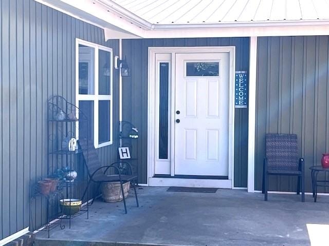 property entrance featuring a standing seam roof and metal roof