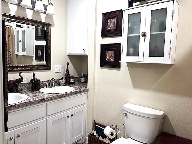 bathroom featuring toilet and vanity