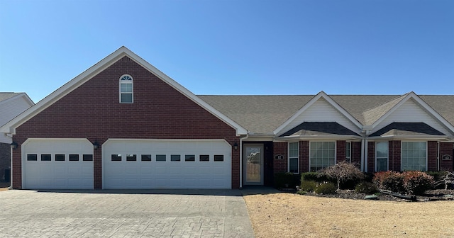 view of front of home featuring brick siding and driveway