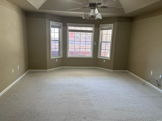 unfurnished room featuring baseboards, light carpet, and a ceiling fan