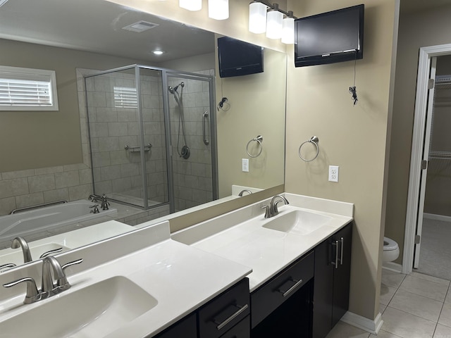 full bathroom featuring a shower stall, double vanity, tile patterned floors, and a sink