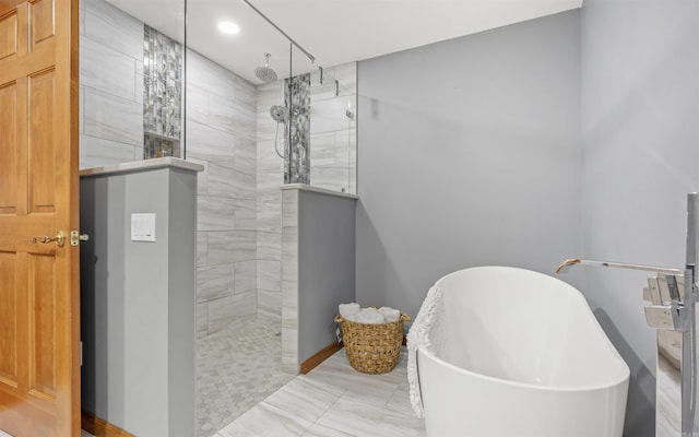 bathroom with a soaking tub, recessed lighting, and a walk in shower