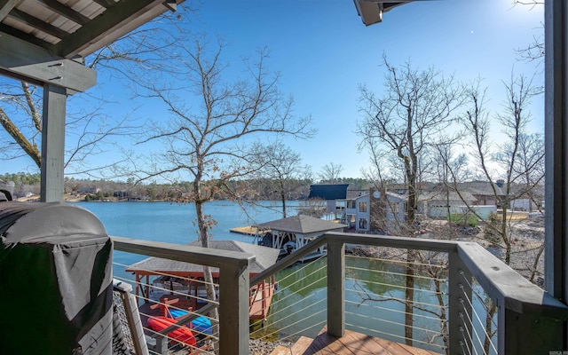 exterior space featuring grilling area and a water view