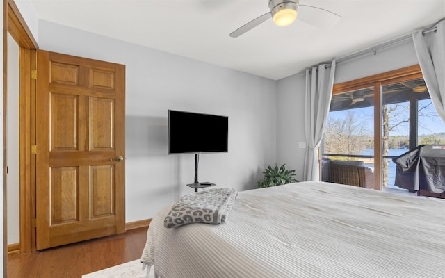 bedroom featuring ceiling fan, wood finished floors, baseboards, and access to outside