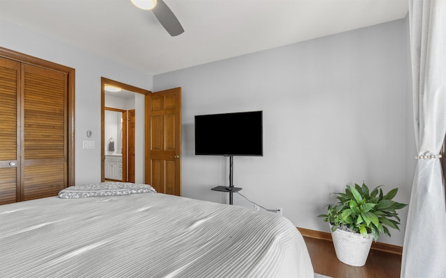 bedroom with a closet, baseboards, wood finished floors, and a ceiling fan