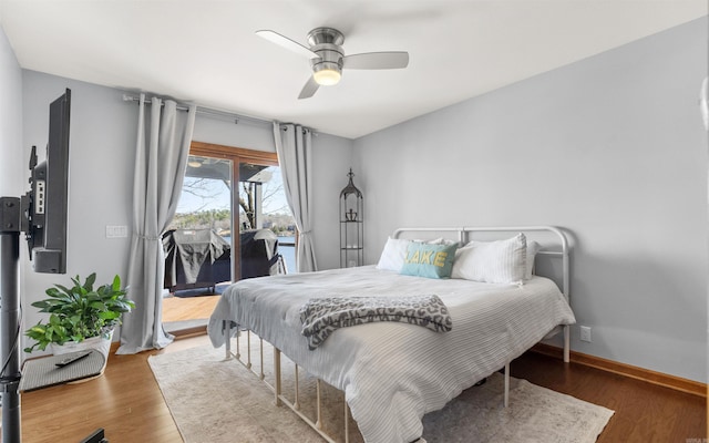 bedroom featuring ceiling fan, baseboards, wood finished floors, and access to exterior