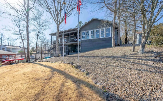 view of front of home with stairway and a front yard