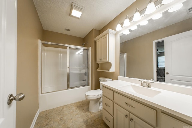 bathroom with visible vents, toilet, vanity, combined bath / shower with glass door, and a textured ceiling