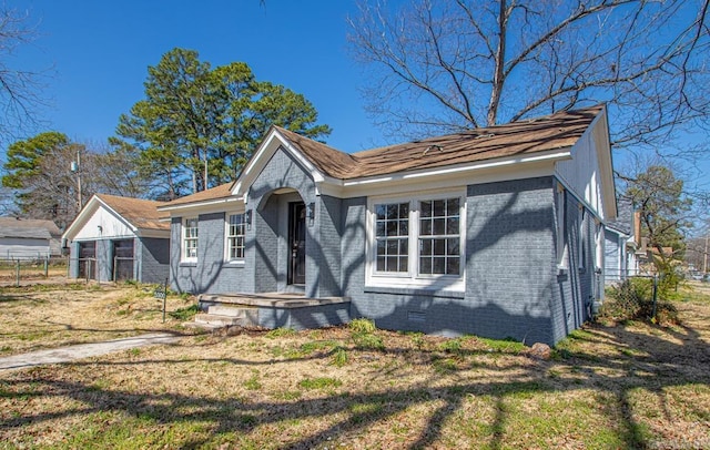 view of front of house featuring crawl space, brick siding, a front lawn, and fence