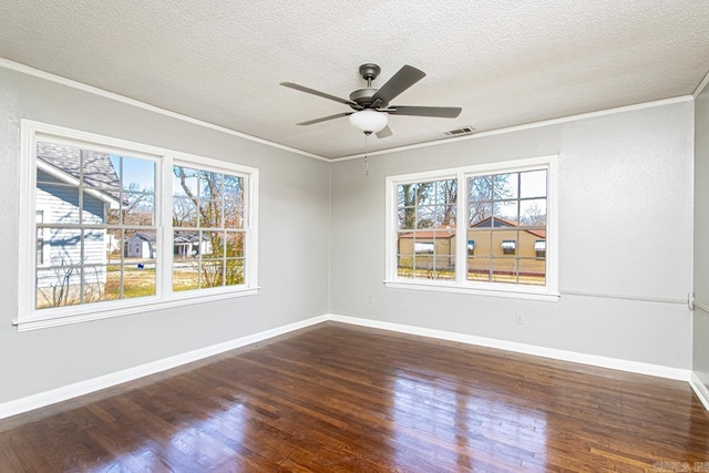 unfurnished room with visible vents, a ceiling fan, ornamental molding, and dark wood-style flooring