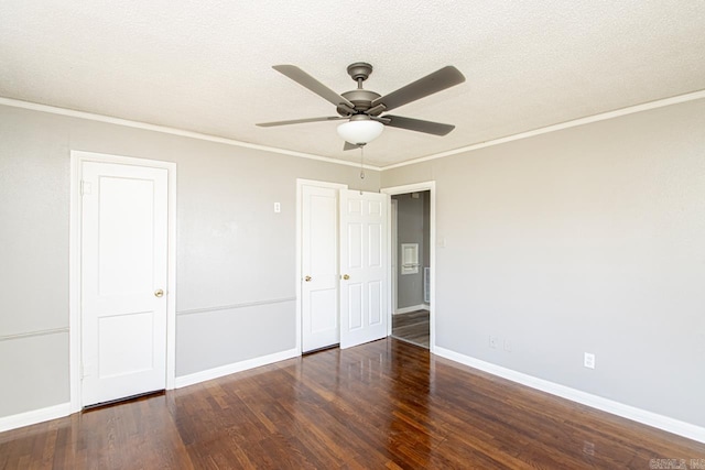 unfurnished bedroom with baseboards, a textured ceiling, wood finished floors, and crown molding