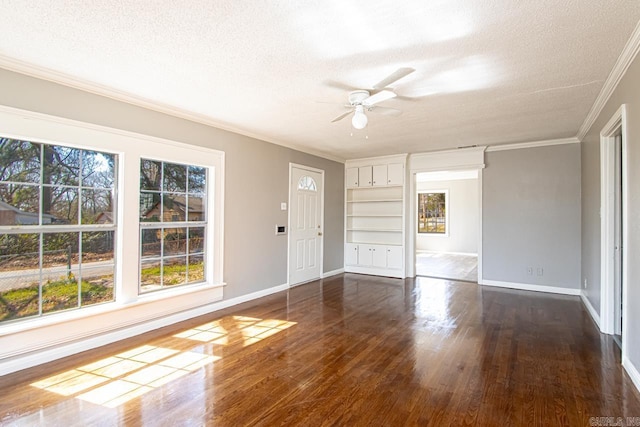 interior space featuring crown molding, baseboards, dark wood-style floors, a textured ceiling, and a ceiling fan