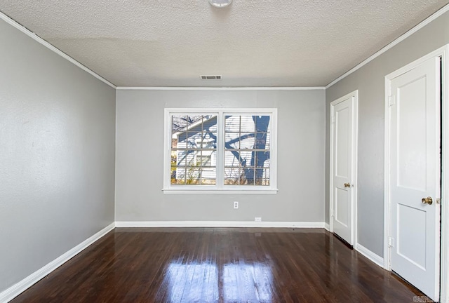 interior space featuring visible vents, crown molding, baseboards, wood finished floors, and a textured ceiling