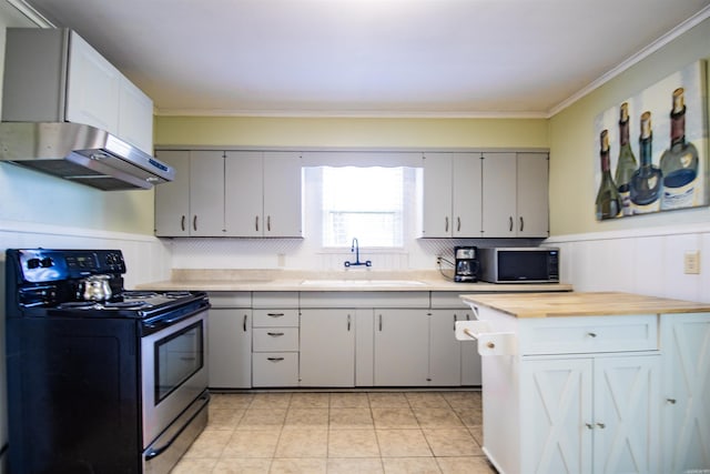 kitchen with ornamental molding, butcher block countertops, a sink, stainless steel range with electric stovetop, and exhaust hood