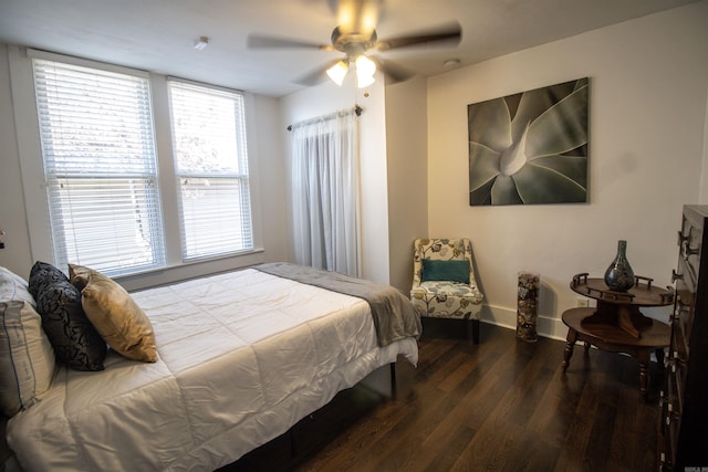 bedroom featuring a ceiling fan, baseboards, and wood finished floors